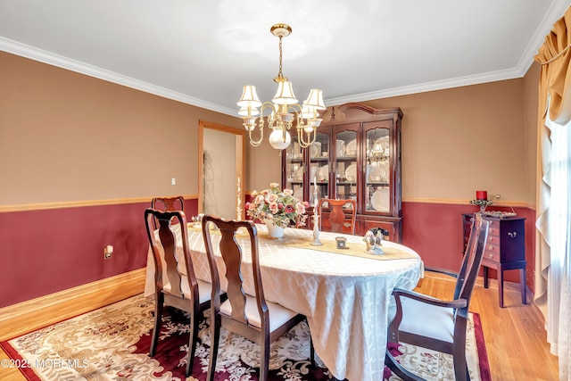 1 River Dr, Farmingdale, NJ 07727 - dining space featuring a chandelier, wood finished floors, ornamental molding, and baseboards