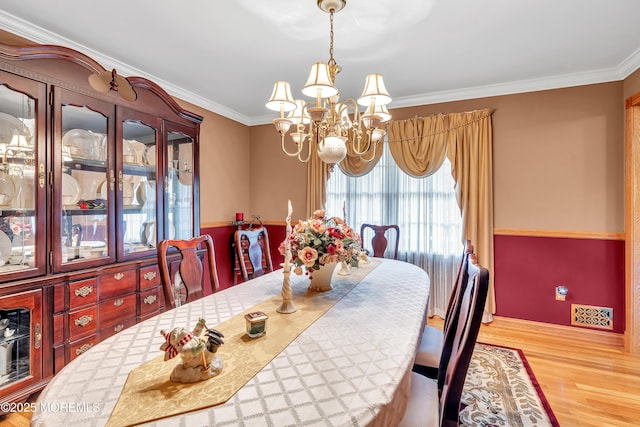 1 River Dr, Farmingdale, NJ 07727 - dining space with a chandelier, wood finished floors, and ornamental molding