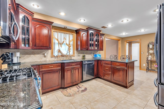 1 River Dr, Farmingdale, NJ 07727 - kitchen featuring stainless steel appliances, a peninsula, backsplash, a sink, and glass insert cabinets