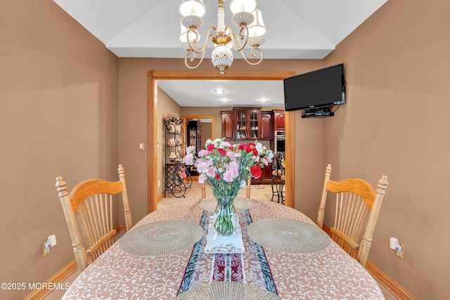 1 River Dr, Farmingdale, NJ 07727 - dining space with a chandelier, baseboards, and vaulted ceiling