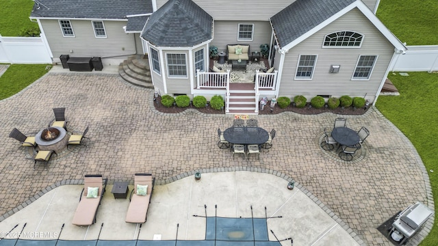 1 River Dr, Farmingdale, NJ 07727 - back of house featuring an outdoor fire pit, a patio, and a hot tub