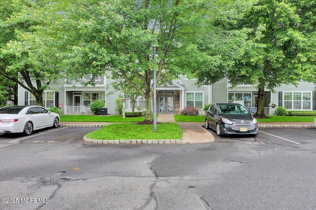 634 Saint Andrews Pl, Manalapan, NJ 07726 - view of property with french doors and uncovered parking