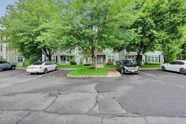 634 Saint Andrews Pl, Manalapan, NJ 07726 - view of property with uncovered parking and french doors
