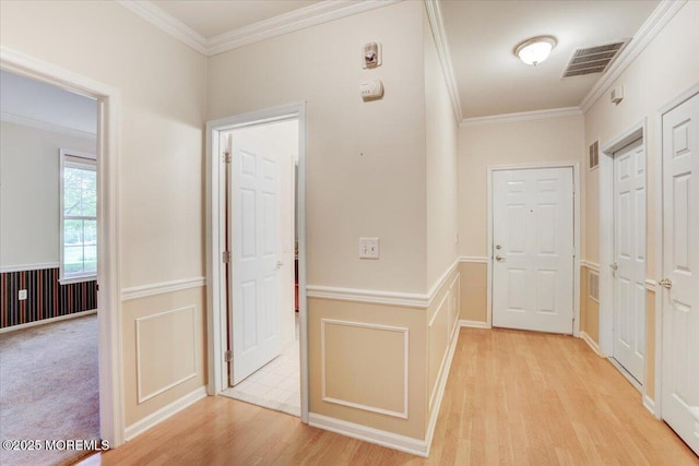 634 Saint Andrews Pl, Manalapan, NJ 07726 - hall with light wood-type flooring, crown molding, and wainscoting
