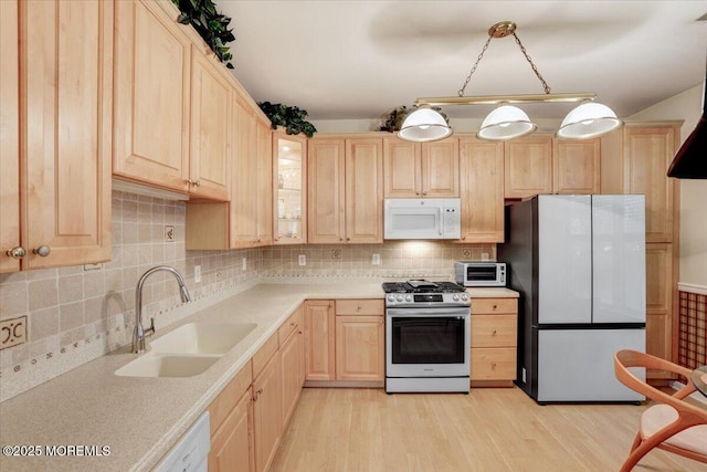 634 Saint Andrews Pl, Manalapan, NJ 07726 - kitchen with appliances with stainless steel finishes, light brown cabinets, a sink, light wood-type flooring, and light countertops