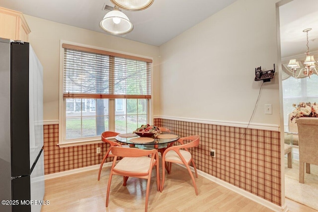 634 Saint Andrews Pl, Manalapan, NJ 07726 - dining space featuring a chandelier, wainscoting, baseboards, wallpapered walls, and light wood finished floors