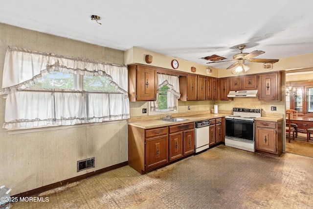 1233 Herkimer Rd, Brick, NJ 08724 - kitchen featuring white appliances, under cabinet range hood, healthy amount of natural light, and light countertops