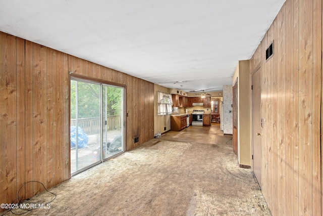 1233 Herkimer Rd, Brick, NJ 08724 - unfurnished living room featuring wood walls and light colored carpet