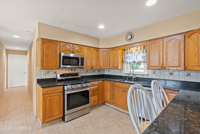 30 Woodland Dr, Howell, NJ 07731 - kitchen featuring stainless steel appliances, a sink, dark stone countertops, light tile patterned flooring, and recessed lighting