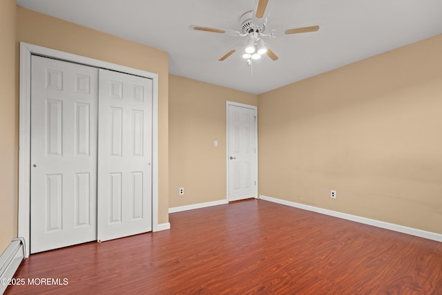 30 Woodland Dr, Howell, NJ 07731 - unfurnished bedroom with baseboard heating, dark wood-type flooring, baseboards, a closet, and a ceiling fan