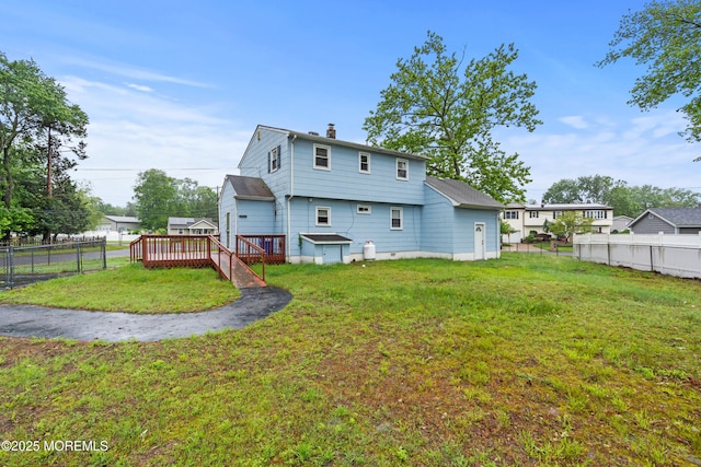 30 Woodland Dr, Howell, NJ 07731 - back of property with a deck and a chimney