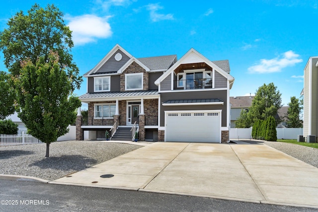 22 Corrigan Ave, Pine Beach, NJ 08741 - craftsman inspired home with a standing seam roof, an attached garage, stone siding, concrete driveway, and covered porch