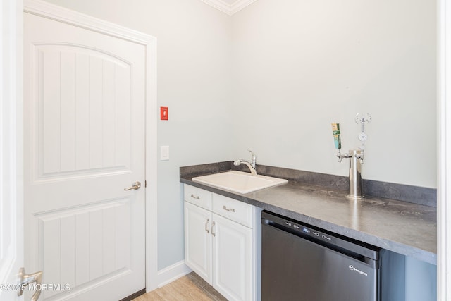 22 Corrigan Ave, Pine Beach, NJ 08741 - kitchen with dishwasher, a sink, dark countertops, white cabinets, and ornamental molding
