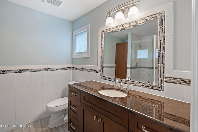 22 Corrigan Ave, Pine Beach, NJ 08741 - bathroom with a stall shower, toilet, vanity, and tile walls