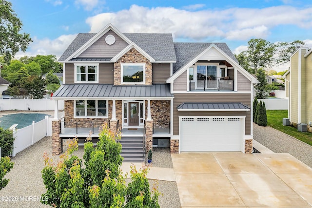 22 Corrigan Ave, Pine Beach, NJ 08741 - craftsman-style home with stone siding, a standing seam roof, a garage, a porch, and roof with shingles