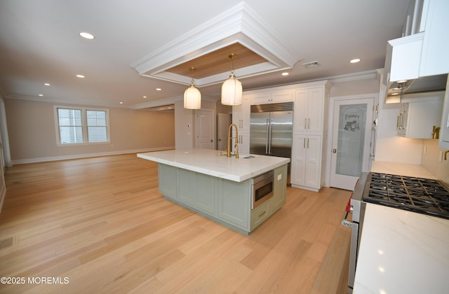 674 Lake Ave, Bay Head, NJ 08742 - kitchen featuring crown molding, built in appliances, white cabinets, light wood-style flooring, and a sink
