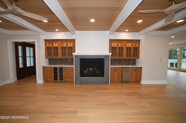 674 Lake Ave, Bay Head, NJ 08742 - unfurnished living room featuring baseboards, wet bar, beamed ceiling, a ceiling fan, and light wood-style flooring