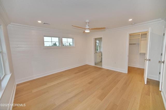 674 Lake Ave, Bay Head, NJ 08742 - unfurnished bedroom featuring crown molding, a spacious closet, baseboards, light wood-style flooring, and a closet