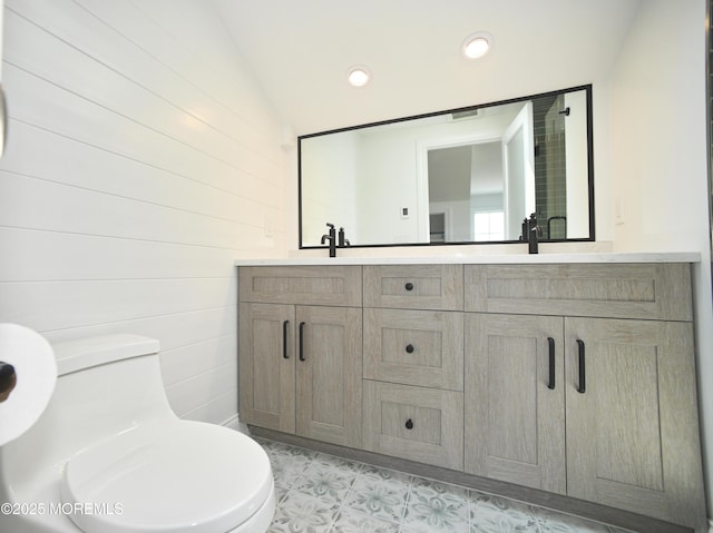 674 Lake Ave, Bay Head, NJ 08742 - full bath with toilet, double vanity, vaulted ceiling, and recessed lighting
