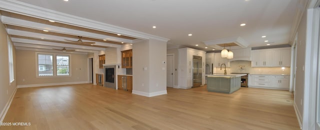 674 Lake Ave, Bay Head, NJ 08742 - kitchen featuring open floor plan, crown molding, decorative backsplash, baseboards, and light countertops