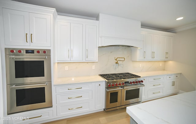674 Lake Ave, Bay Head, NJ 08742 - kitchen with stainless steel appliances, white cabinetry, light stone countertops, crown molding, and recessed lighting