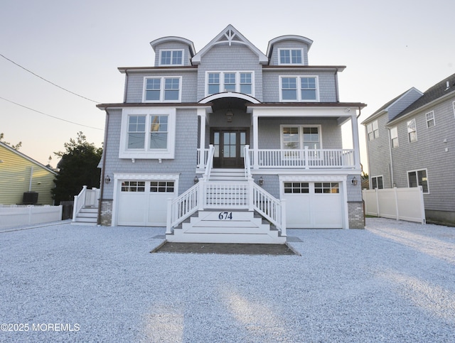 674 Lake Ave, Bay Head, NJ 08742 - view of front of home featuring stairs, an attached garage, covered porch, and gravel driveway