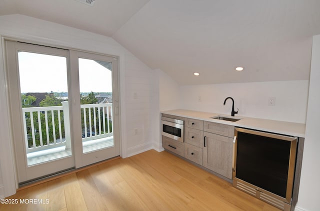 674 Lake Ave, Bay Head, NJ 08742 - kitchen with a sink, beverage cooler, lofted ceiling, light wood-style flooring, and light countertops