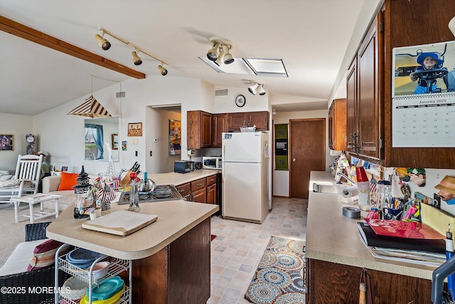 1107 Uranus Ct, Forked River, NJ 08731 - kitchen featuring freestanding refrigerator, lofted ceiling, light countertops, a peninsula, and a kitchen breakfast bar