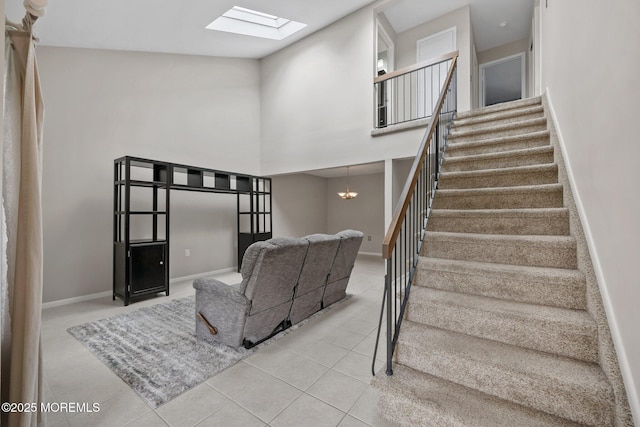 1 Independence Way, Howell, NJ 07731 - living area featuring a skylight, a towering ceiling, tile patterned flooring, stairs, and baseboards