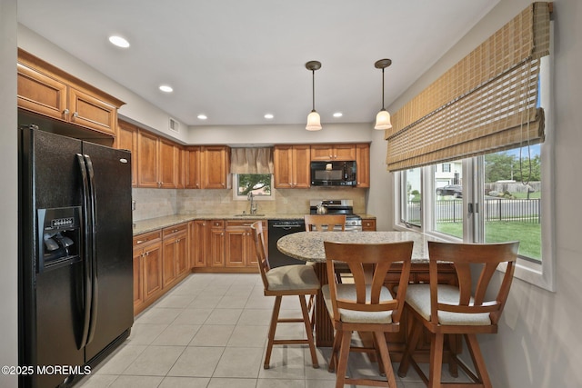 1 Independence Way, Howell, NJ 07731 - kitchen featuring black appliances, tasteful backsplash, light tile patterned floors, light stone countertops, and a sink