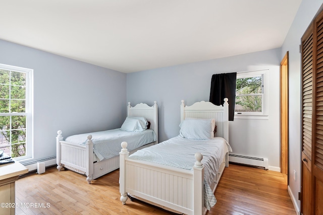 1015 Barnacle Dr, Manahawkin, NJ 08050 - bedroom with a baseboard heating unit, multiple windows, and light wood-style floors