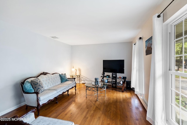 1015 Barnacle Dr, Manahawkin, NJ 08050 - living area featuring wood finished floors, baseboards, and a baseboard heating unit