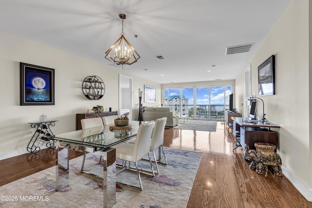 432 Ocean Blvd N Unit 506, Long Branch, NJ 07740 - dining area with a chandelier, wood finished floors, and baseboards