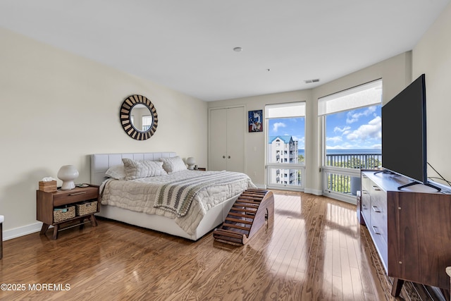 432 Ocean Blvd N Unit 506, Long Branch, NJ 07740 - bedroom featuring wood finished floors, access to exterior, and baseboards