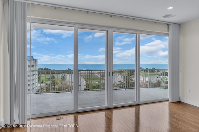 432 Ocean Blvd N Unit 506, Long Branch, NJ 07740 - spare room with a water view, wood finished floors, recessed lighting, and baseboards