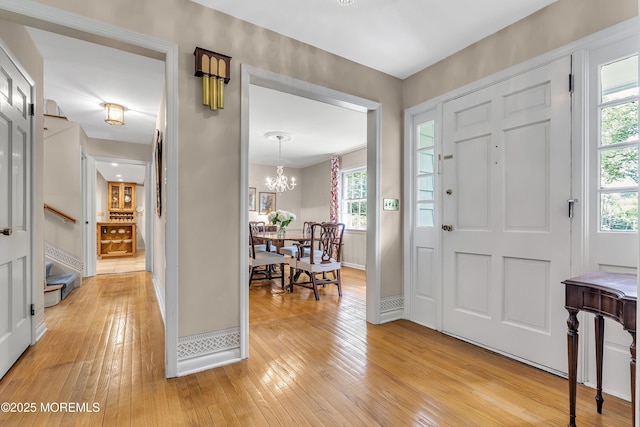 49 Crane Ct, Middletown, NJ 07748 - entryway featuring light wood-style flooring, a chandelier, and baseboards