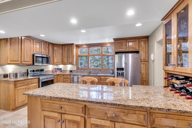 49 Crane Ct, Middletown, NJ 07748 - kitchen with stainless steel appliances, a sink, light stone countertops, recessed lighting, and glass insert cabinets