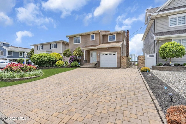 221 Bay Stream Dr, Toms River, NJ 08753 - view of front of house featuring decorative driveway and a gate