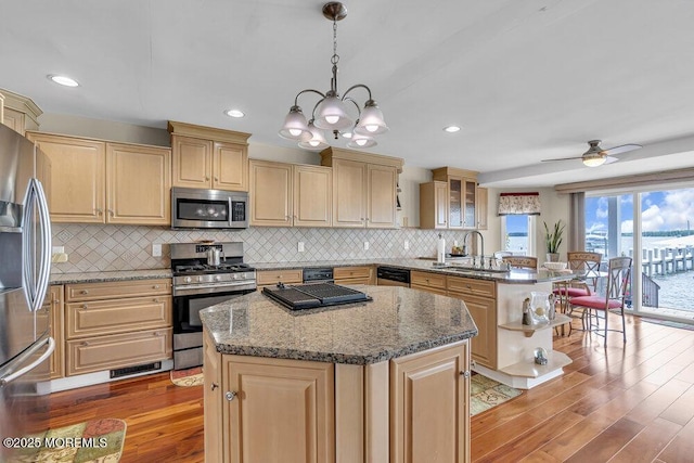 221 Bay Stream Dr, Toms River, NJ 08753 - kitchen featuring appliances with stainless steel finishes, a sink, a peninsula, light wood-style flooring, and recessed lighting