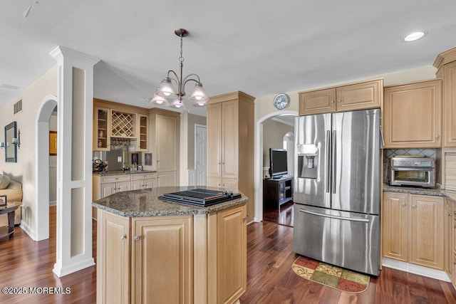 221 Bay Stream Dr, Toms River, NJ 08753 - kitchen featuring stainless steel refrigerator with ice dispenser, arched walkways, black cooktop, dark stone counters, and dark wood-style floors