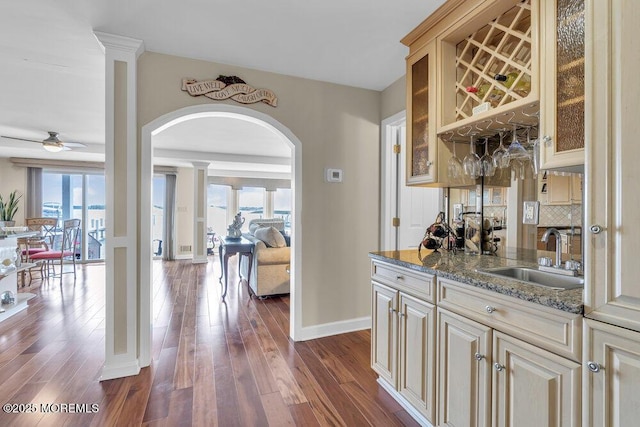 221 Bay Stream Dr, Toms River, NJ 08753 - indoor bar with arched walkways, dark wood finished floors, baseboards, a ceiling fan, and tasteful backsplash