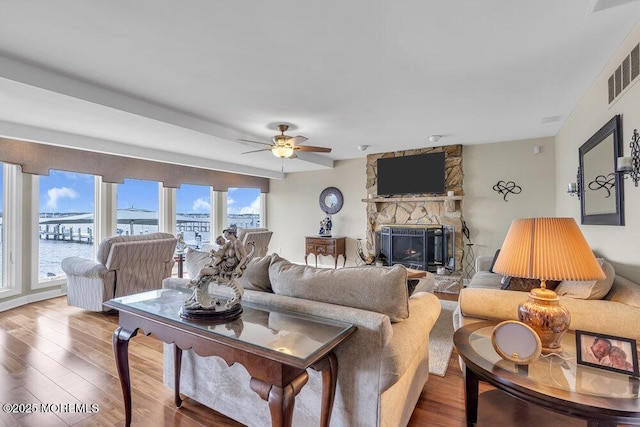 221 Bay Stream Dr, Toms River, NJ 08753 - living room featuring wood finished floors, a stone fireplace, and a ceiling fan