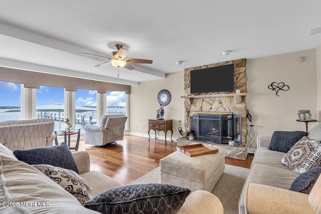 221 Bay Stream Dr, Toms River, NJ 08753 - living room with a fireplace, wood finished floors, ceiling fan, baseboards, and a water view