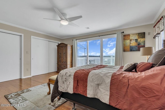 221 Bay Stream Dr, Toms River, NJ 08753 - bedroom featuring access to exterior, wood finished floors, crown molding, two closets, and a ceiling fan
