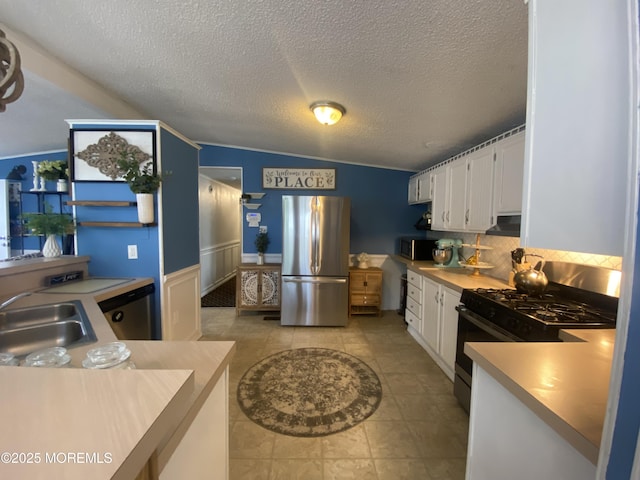 89 Seattle Slew Dr, Howell, NJ 07731 - kitchen with freestanding refrigerator, gas range, a sink, white cabinets, and light countertops