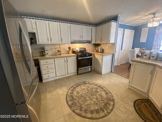 89 Seattle Slew Dr, Howell, NJ 07731 - kitchen featuring stainless steel appliances, light countertops, decorative backsplash, a textured ceiling, and ceiling fan