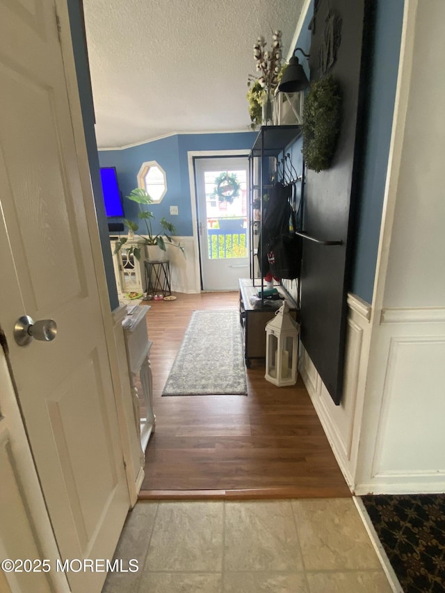 89 Seattle Slew Dr, Howell, NJ 07731 - living room featuring a textured ceiling, wood finished floors, and wainscoting
