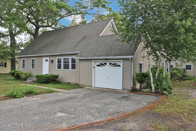 122 Oakwood Pl, Forked River, NJ 08731 - new england style home with a garage, roof with shingles, and asphalt driveway