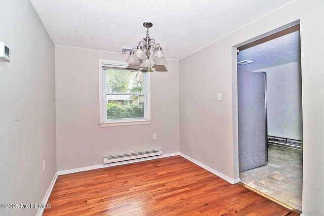 122 Oakwood Pl, Forked River, NJ 08731 - unfurnished room featuring a baseboard radiator, a chandelier, light wood-style flooring, baseboards, and a textured ceiling