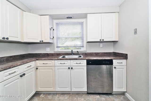 122 Oakwood Pl, Forked River, NJ 08731 - kitchen with stainless steel dishwasher, a sink, dark countertops, white cabinetry, and light stone finish flooring